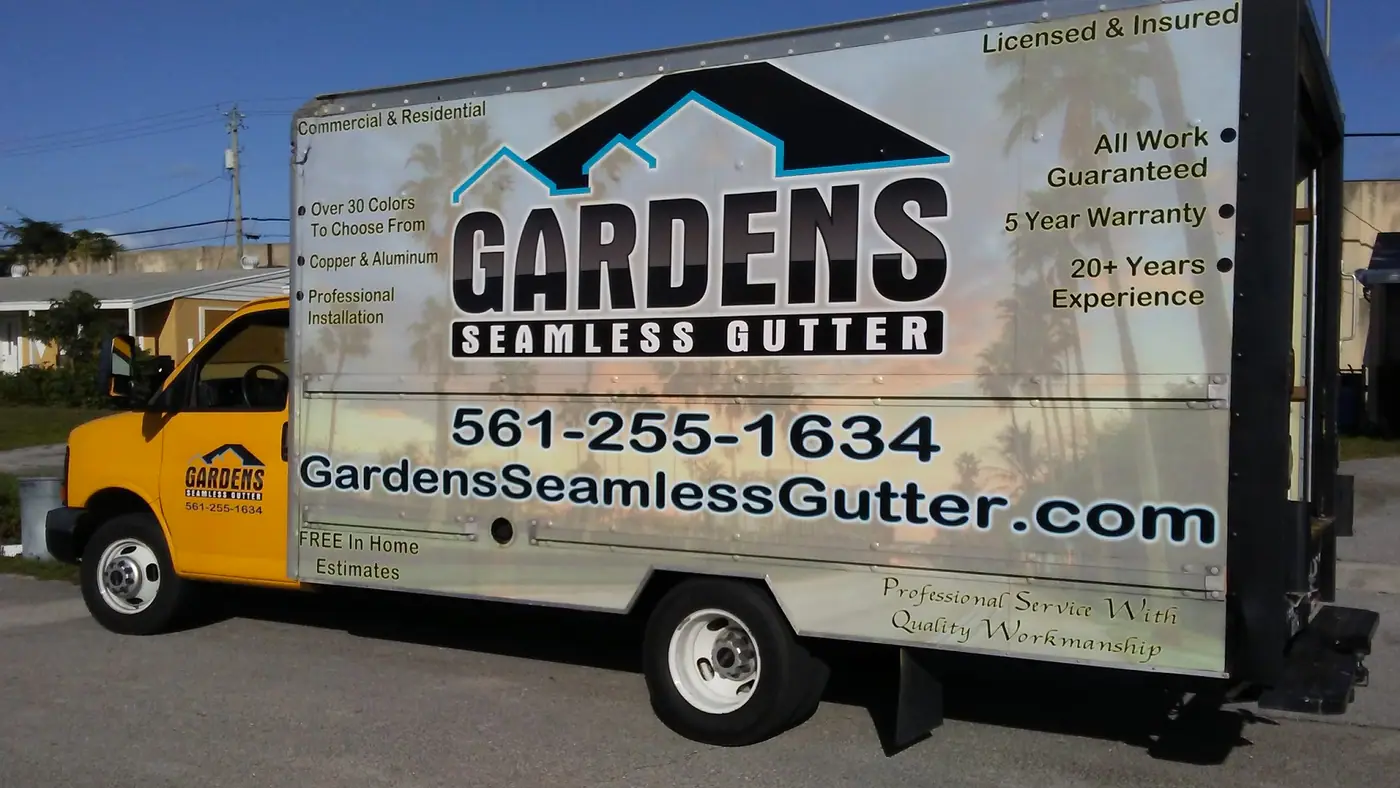 Gardens Seamless Gutter box truck with the company logo and phone number